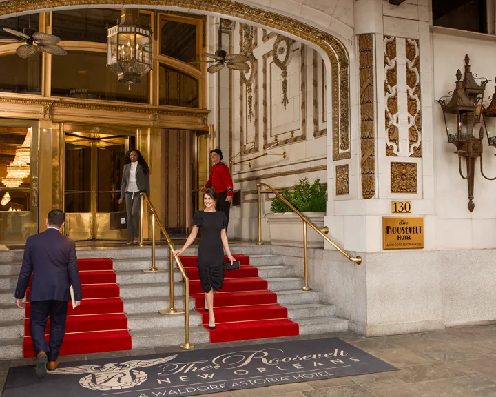 Woman Dressed Up Walking Down The Stairs Of The Roosevelt Entrance