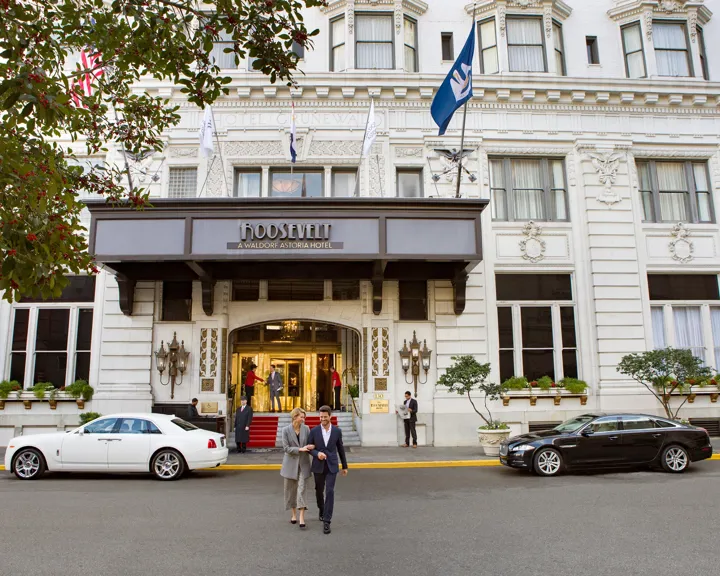 Couple Walking Out Of The Roosevelt New Orleans Entrance
