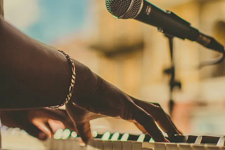 Person Playing The Piano And Singing